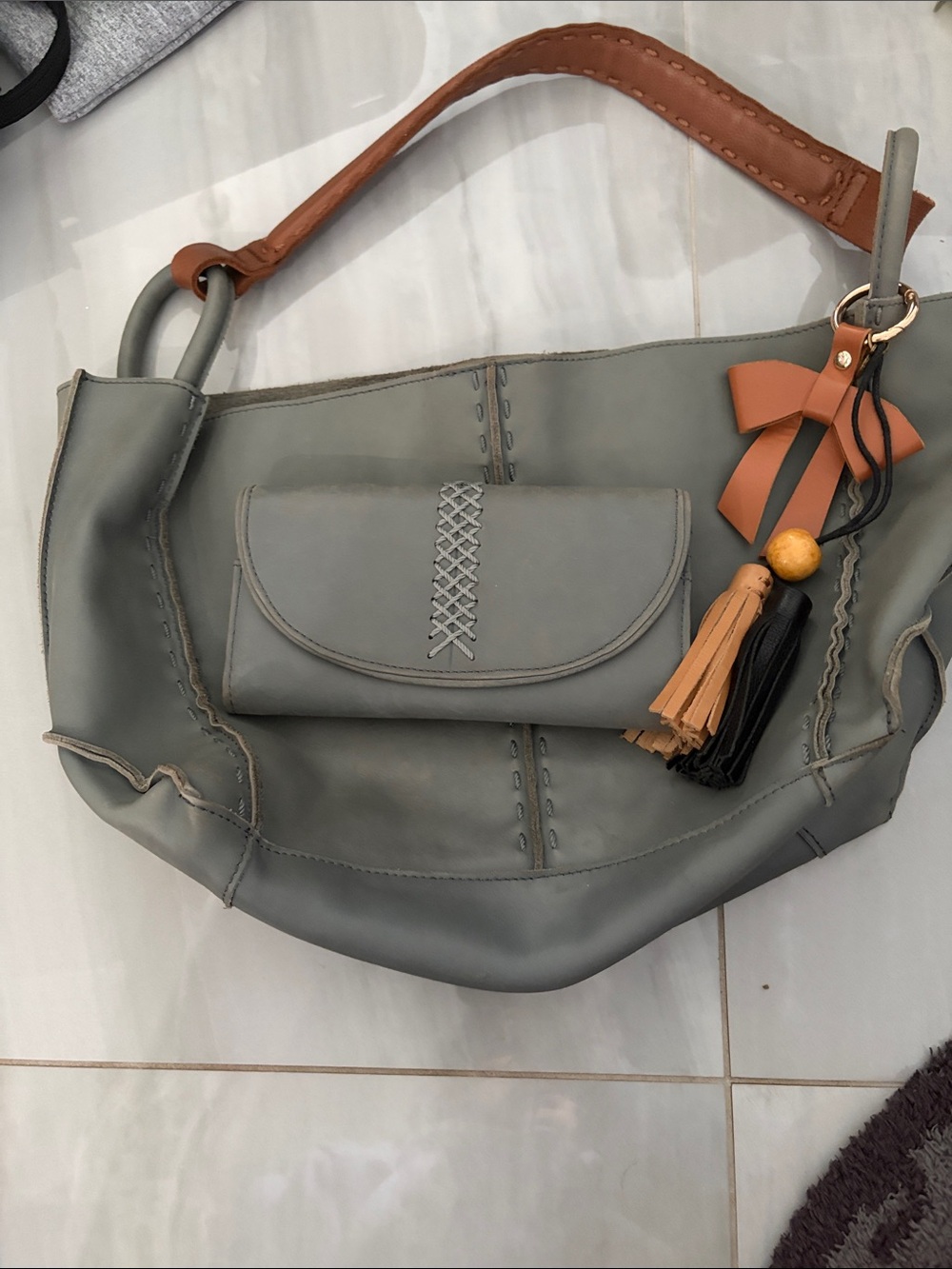 The Sak Los Feliz Gray Leather Bag with Tan Accents and Tassel Charm